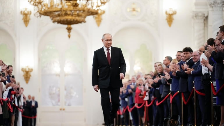 Vladimir Putin walks to take his oath as Russian president...