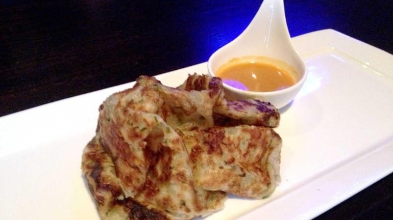 Roti canai, a Malaysian flatbread, is one of the appetizers...