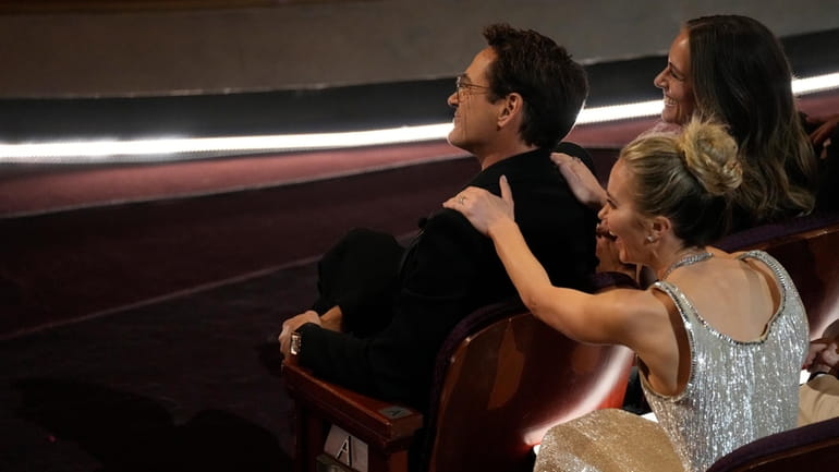 Robert Downey Jr., left, and Emily Blunt appear in the...