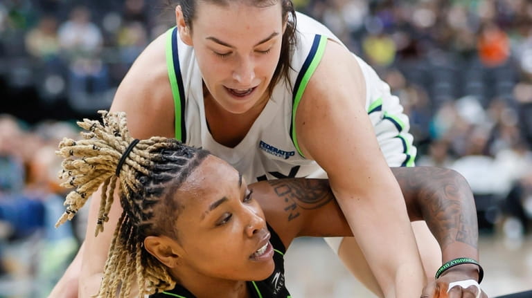 Seattle Storm guard Jordan Horston goes to the floor to...