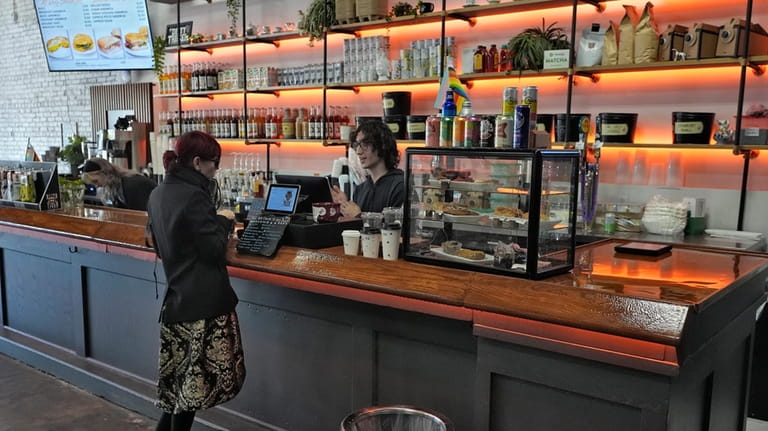 A customer buys a cup of coffee at the Blind...