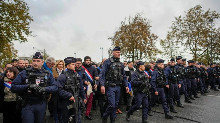 French police regulate thousands who gathered for a march against...