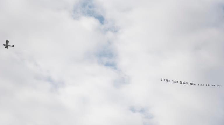 A plane bearing a banner that reads ""We stand with...
