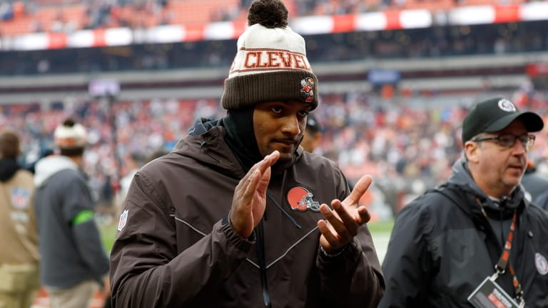 Injured Cleveland Browns quarterback Deshaun Watson applauds as he walks...