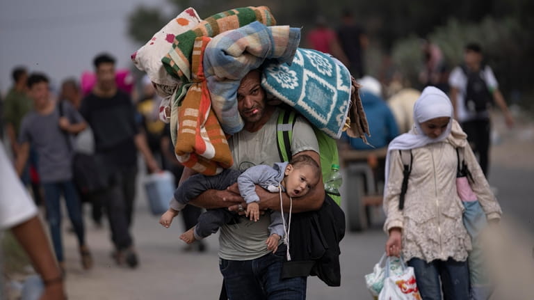 Palestinians flee to the southern Gaza Strip on Salah al-Din...