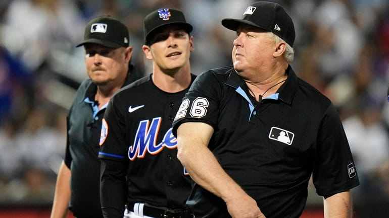 Umpire Bill Miller, right, ejects Mets reliever Drew Smith during...