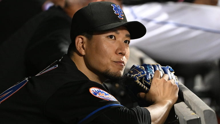 Mets starting pitcher Kodai Senga looks from the dugout during...