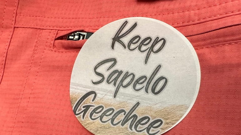 A sticker saying "Keep Sapelo Geechee" is worn on the...