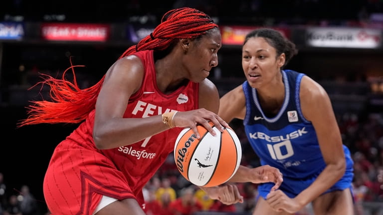 Indiana Fever's Aliyah Boston (7) goes to the basket against...