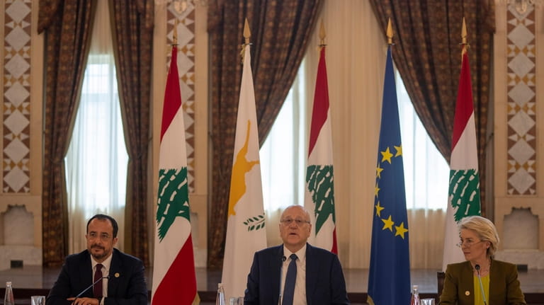 Lebanese caretaker Prime Minister Najib Mikati, center, speaks during his...