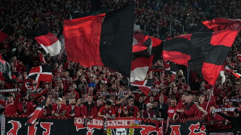 Bayer Leverkusen fans cheer during the Europa League semifinal first...