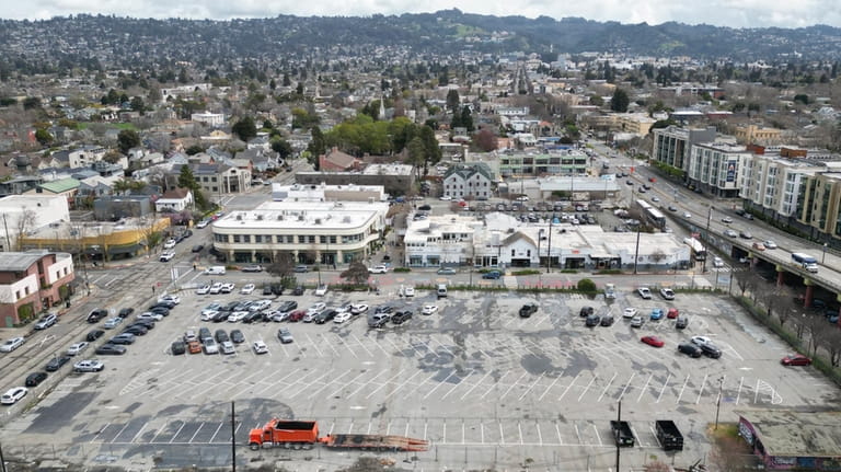 An aerial view is a parking lot that was once...