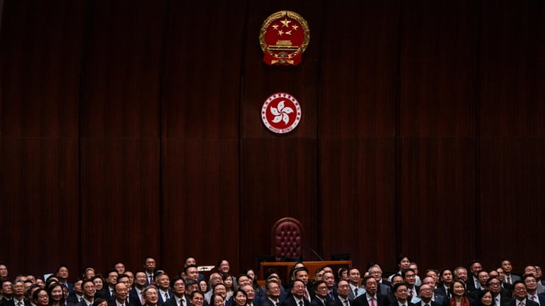 Hong Kong's Chief Executive John Lee, fifth foreground left, pose...