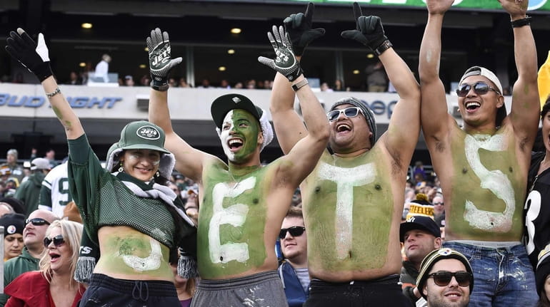 Jets fans celebrate during the second half of a game...