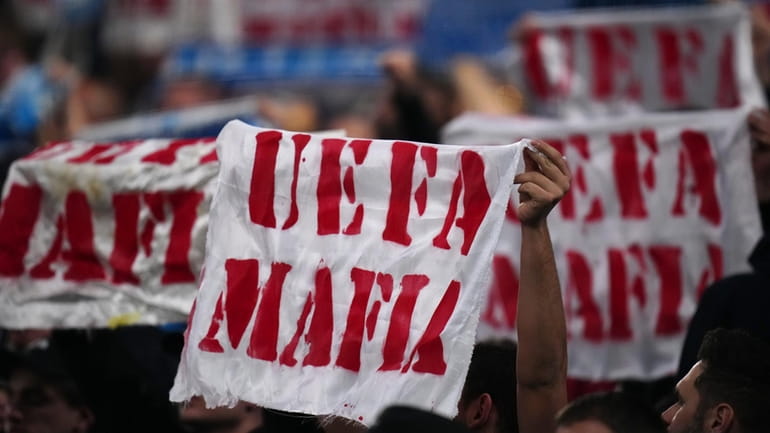 Marseilles fans hold up banners saying "UEFA Mafia" during the...