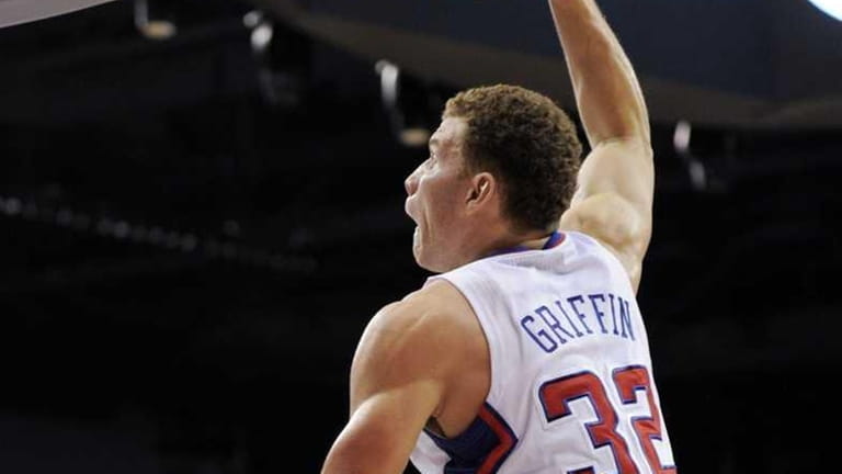 Clippers forward Blake Griffin, right, dunks over Knicks center Timofey...