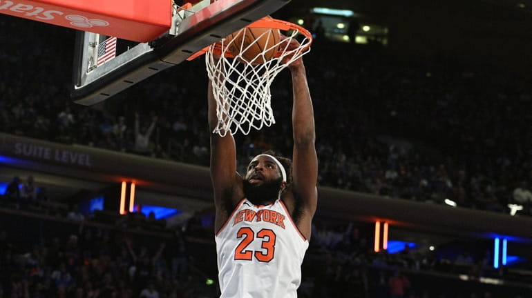 Knicks center Mitchell Robinson dunks in overtime against the Charlotte...