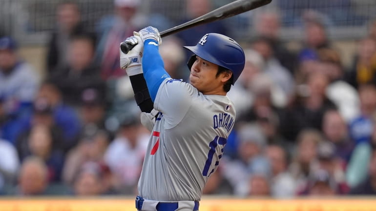 Los Angeles Dodgers designated hitter Shohei Ohtani hits a double...