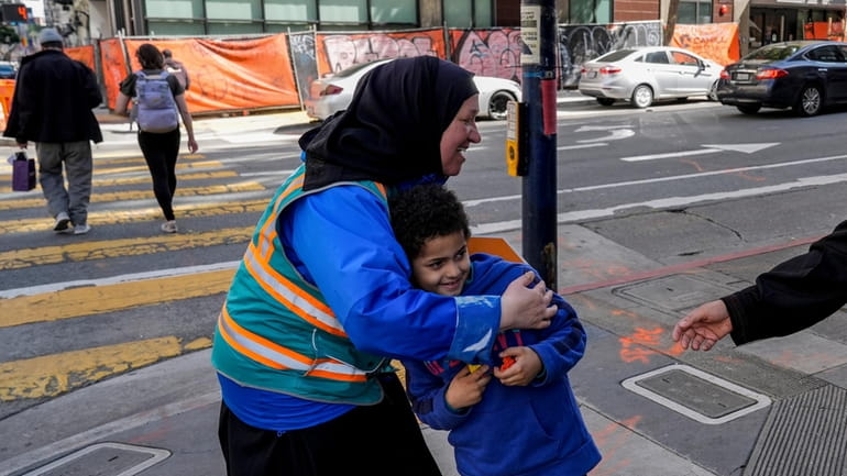 Tatiana Alabsi, left, hugs her nephew Adam Khalid as she...