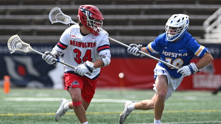 Dylan Pallonetti #34 of Stony Brook, left, gets pressured by...