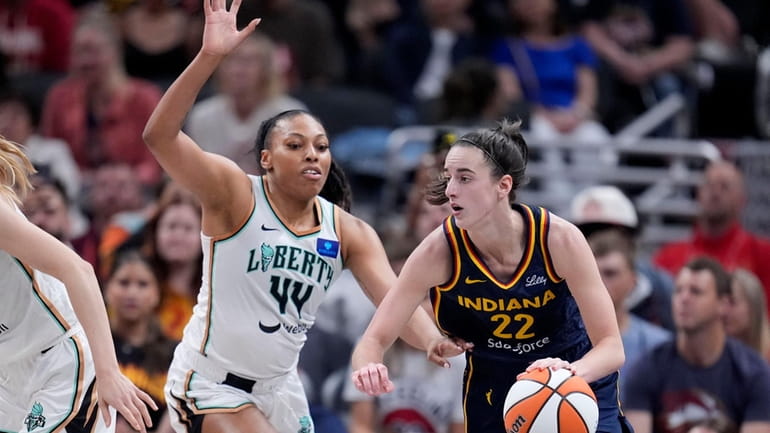 Indiana Fever guard Caitlin Clark (22) drives past New York...
