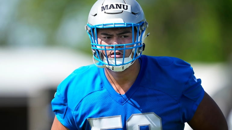 Detroit Lions offensive lineman Giovanni Manu is seen during an...