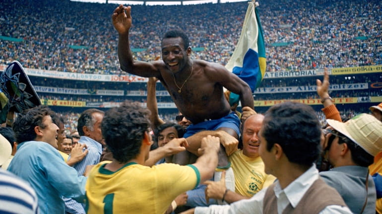 FILE - Brazil's Pele is hoisted on the shoulders of...