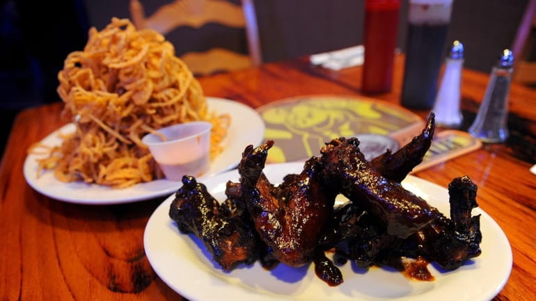 "Fatty Wings" are served with a heaping of onion straws...