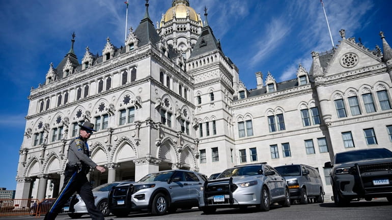 Police vehicles are stationed outside the Connecticut State Capitol on...
