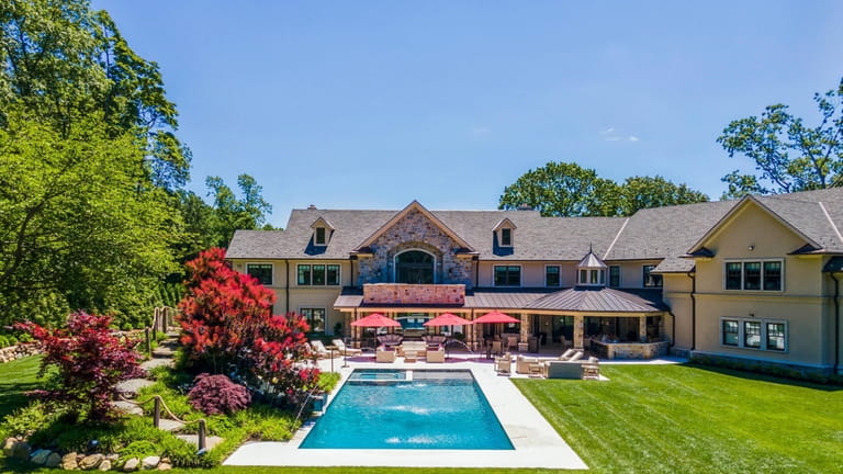 The property sports an in-ground pool with a slide and waterfall.