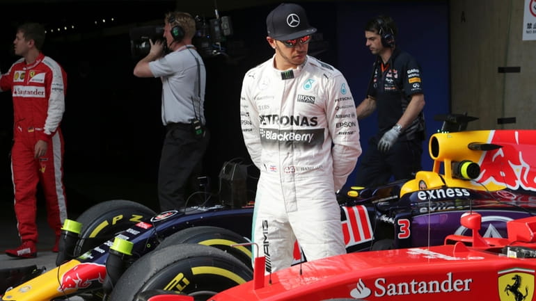 Mercedes driver Lewis Hamilton of Britain looks at Finnish driver...