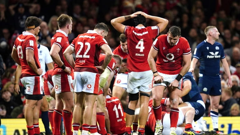 Wales players look dejected after their Six Nations rugby union...