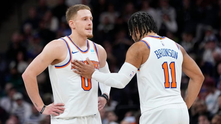 Knicks guard Donte DiVincenzo and guard Jalen Brunson stand together during the...