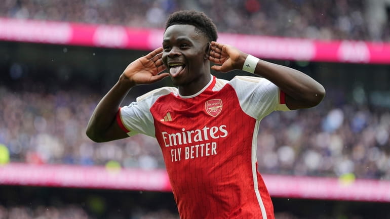 Arsenal's Bukayo Saka celebrates after scoring his side's second goal...