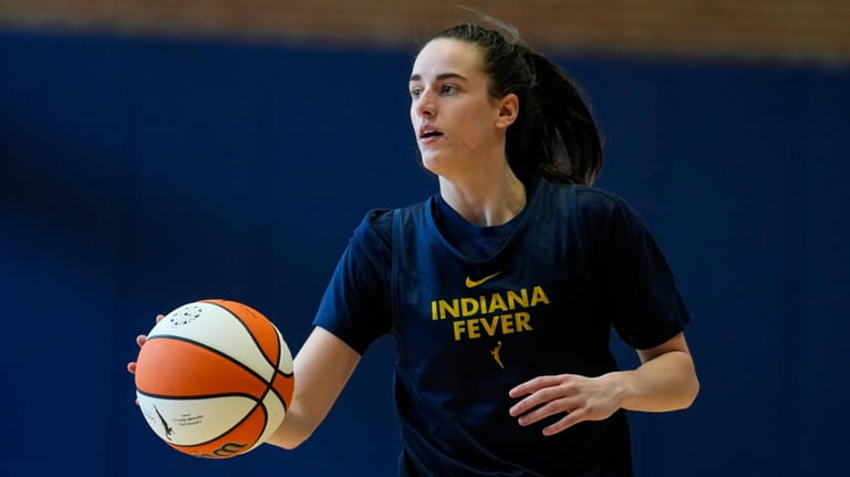 Indiana Fever guard Caitlin Clark brings the ball upcourt as...