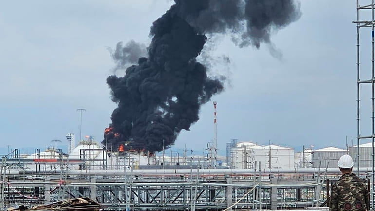 Black smoke billows after an explosion at the gas storage...