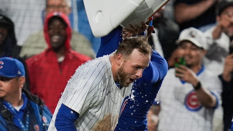 Chicago Cubs' Michael Busch gets doused as he celebrates his...