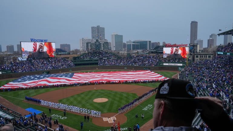 A large American flag is displayed during the Star-Spangled Banner...