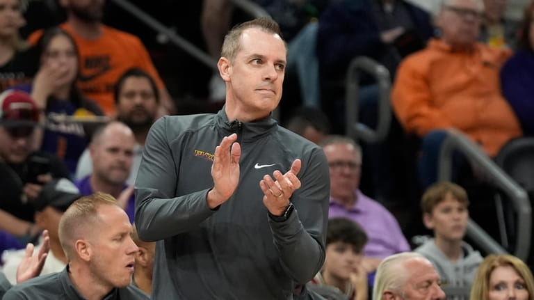 Phoenix Suns head coach Frank Vogel applauds his players during...