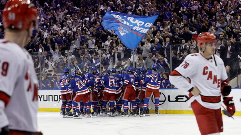 The New York Rangers celebrate their double overtime victory against...