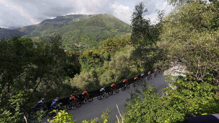 The pack of cyclists rides during the fifth stage of...