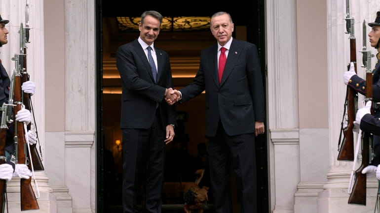 Greece's Prime Minister Kyriakos Mitsotakis, left, welcomes the Turkey's President...
