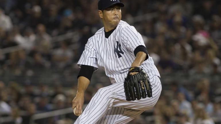 Hiroki Kuroda delivers a pitch in the top of the...