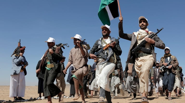 File - Houthi fighters march during a rally of support...