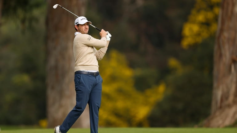 Patrick Cantlay hits from the fairway on the 13th hole...