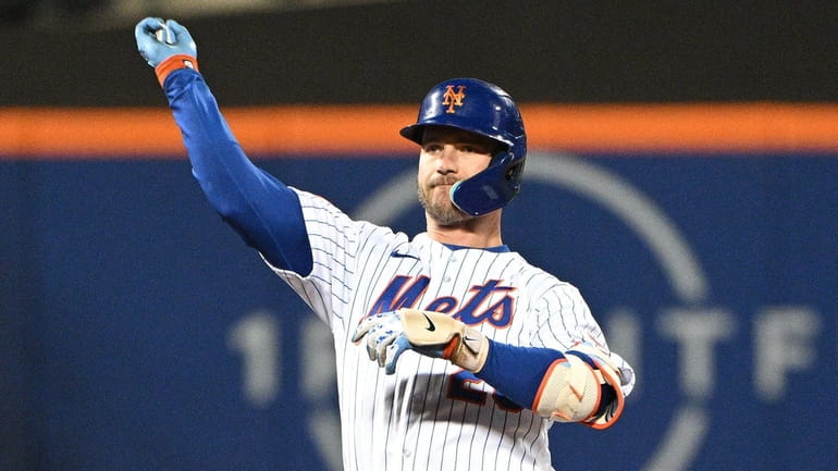 Mets' Pete Alonso gestures on second base after his RBI...