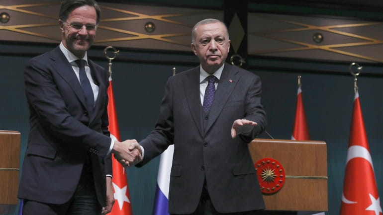 FILE -Turkish President Recep Tayyip Erdogan, right, and Dutch Prime...