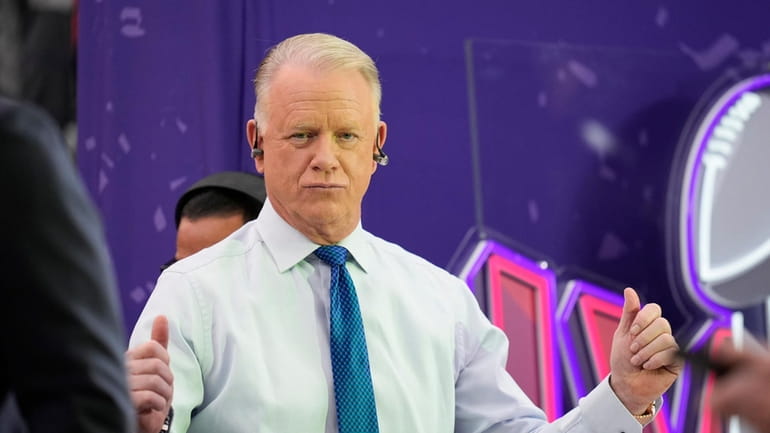 Boomer Esiason interacts with fans before Super Bowl 58 on...