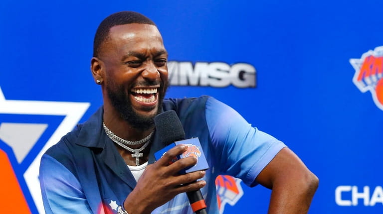 Knicks point guard Kemba Walker smiles during a news conference...