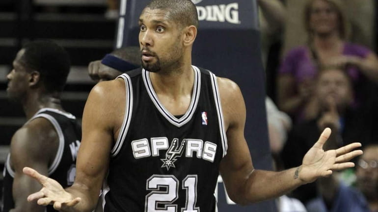 San Antonio Spurs center Tim Duncan reacts to an official's...